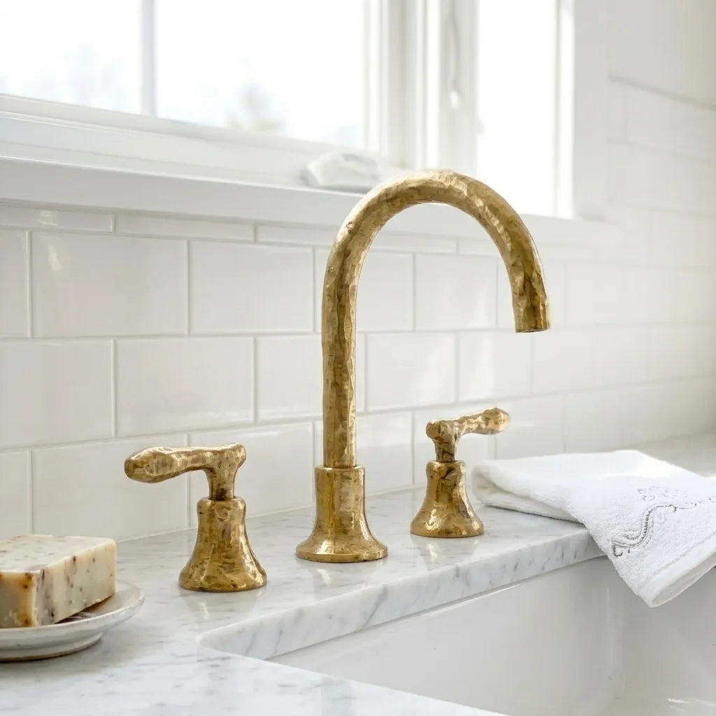 Hand forged brass sink mixer featuring a high curved spout and artisan hammered finish for luxury bathrooms