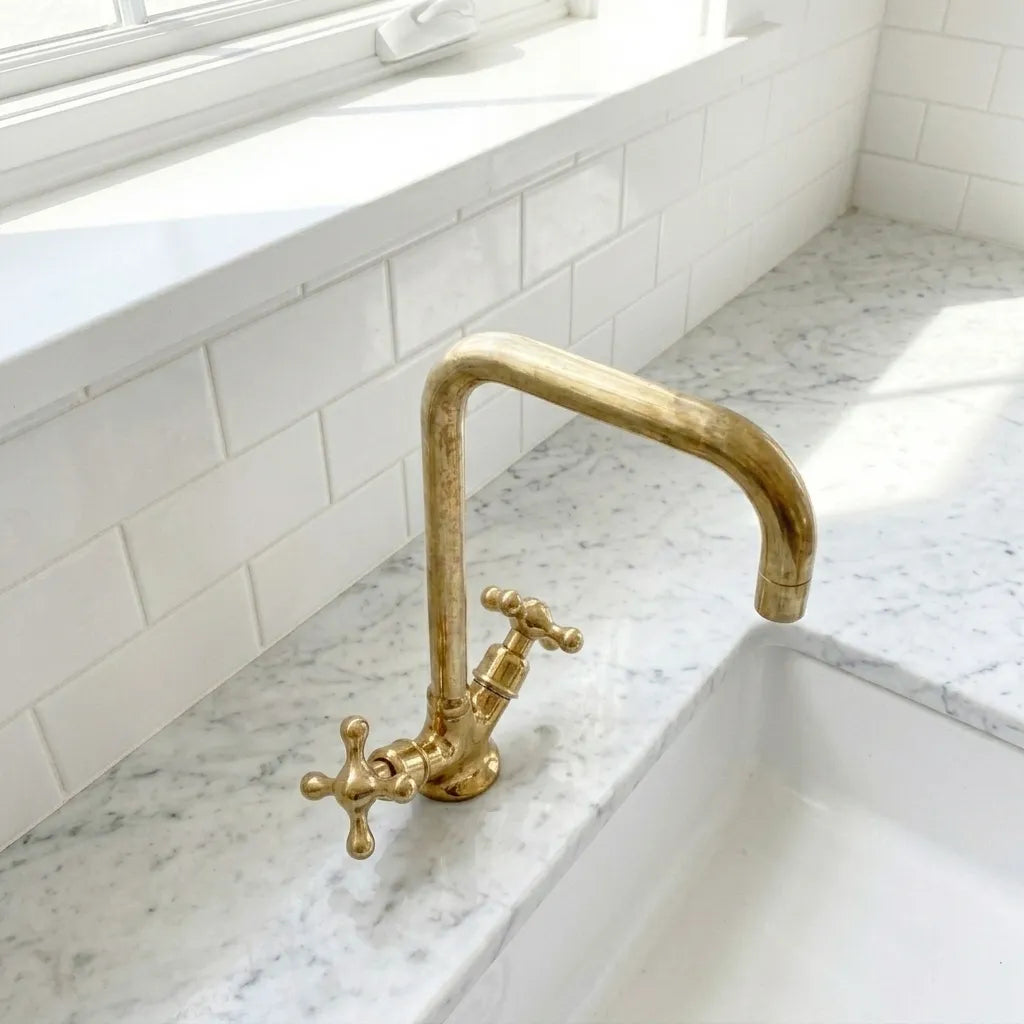 Solid brass sink mixer tap featuring a high angular spout and classic cross controls in a bright bathroom setting
