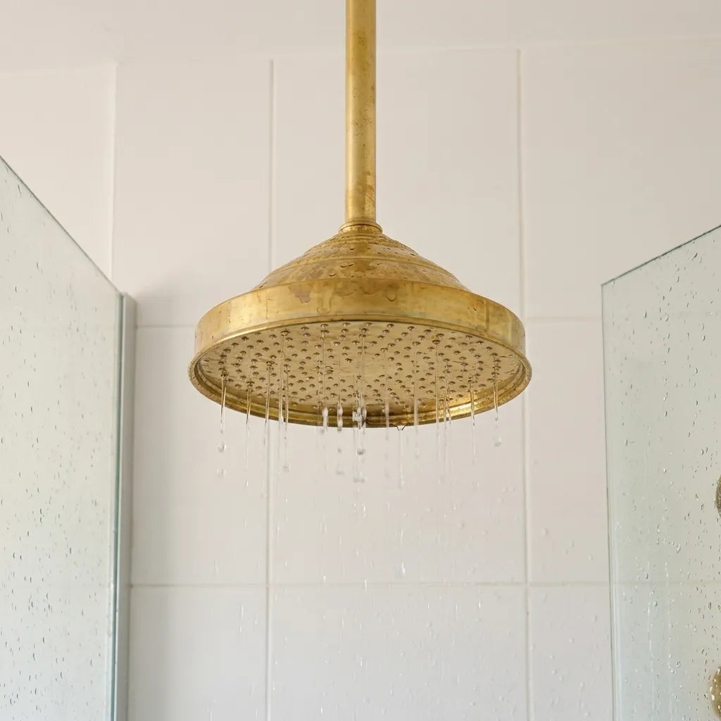 Luxury unlacquered brass shower set with overhead rain shower, handheld sprayer, and built-in mixer valves.