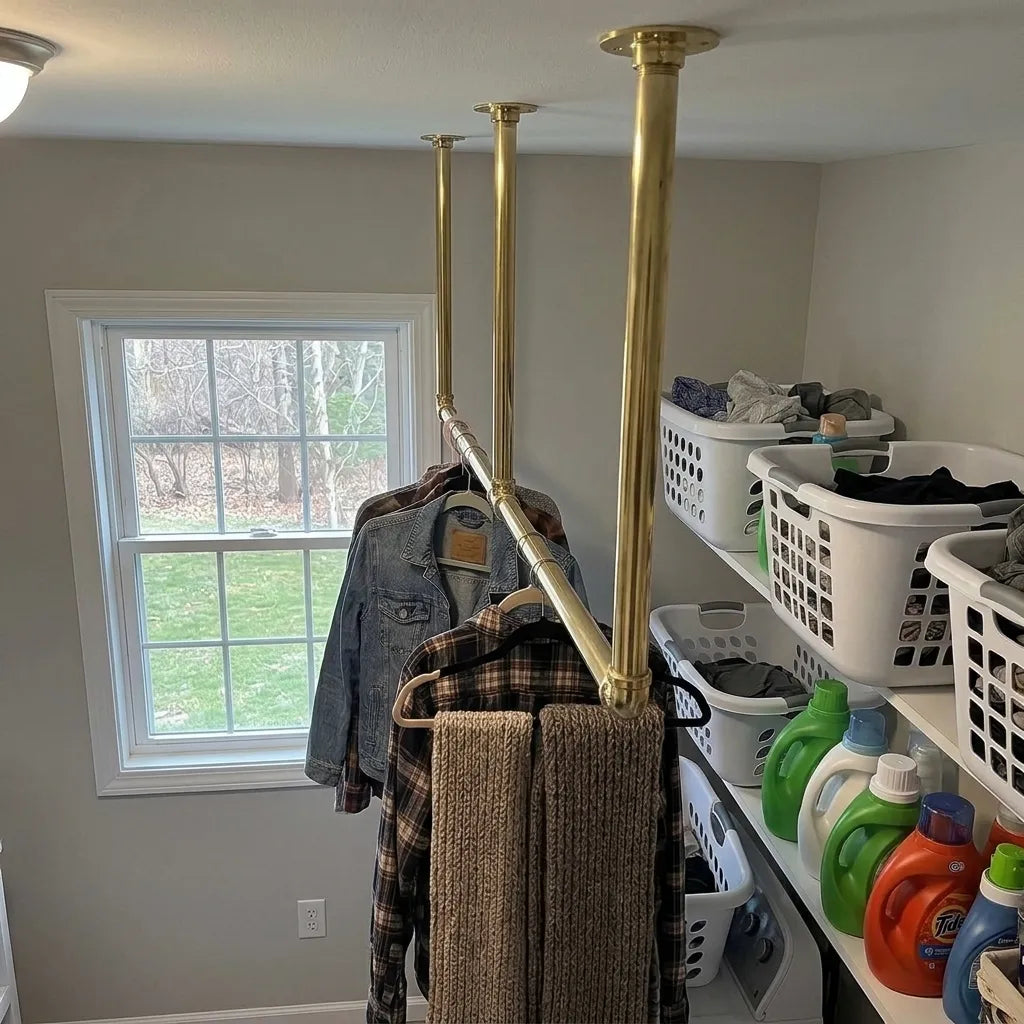 Ceiling mounted brass garment rack for utility room