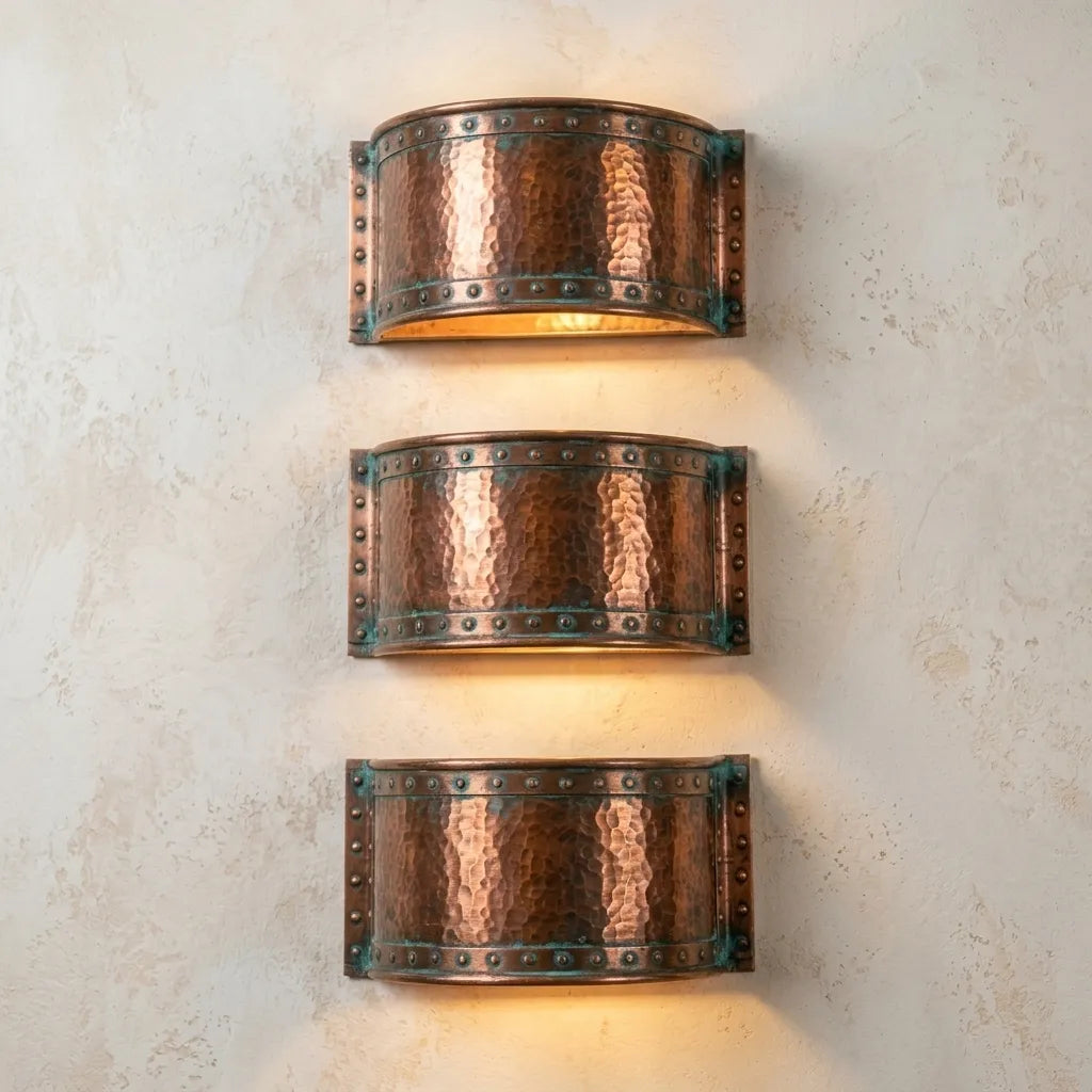 Rustic copper wall light featuring a hammered finish and oxidized verdigris accent bands.