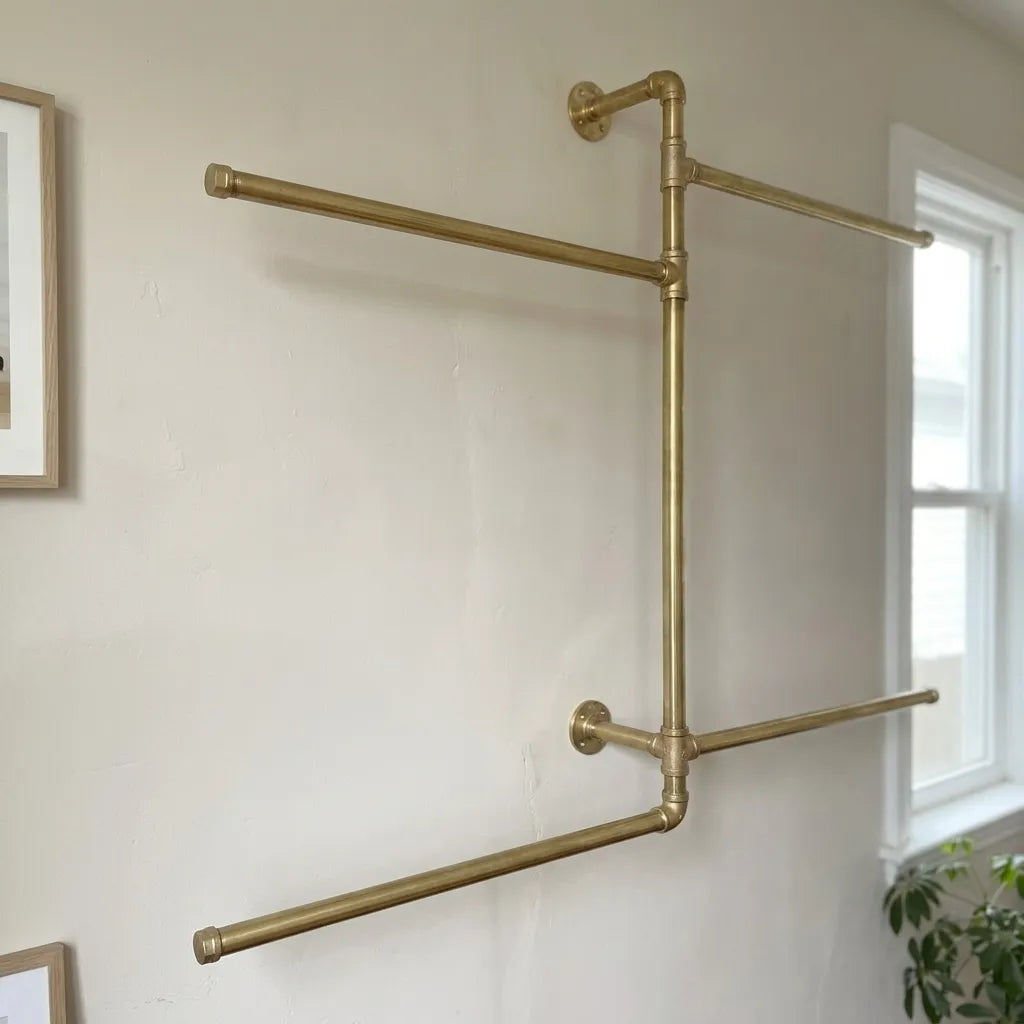 Wall-mounted brass storage rack with multiple hanging bars