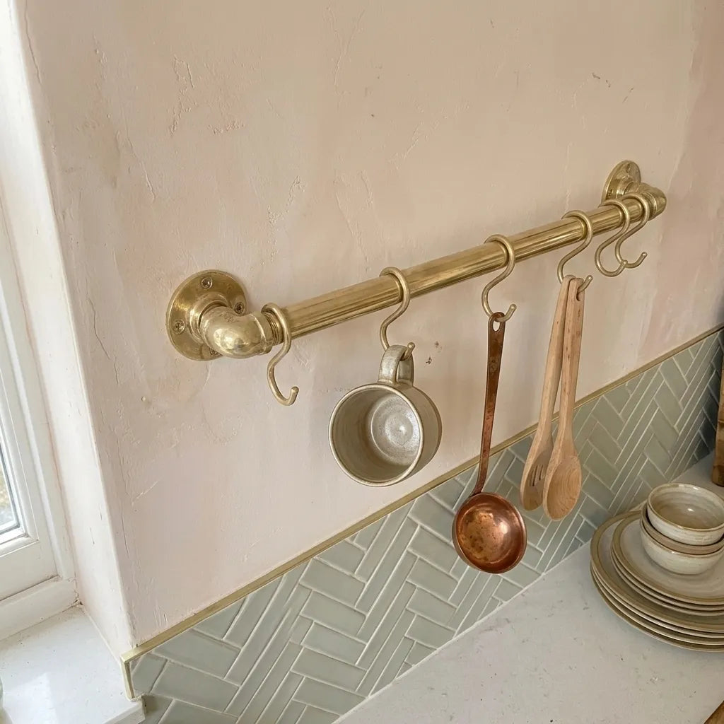 Brass kitchen organization bar with hanging hooks