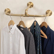 Solid brass three point ceiling clothes rail with dual wall supports for wardrobe storage.