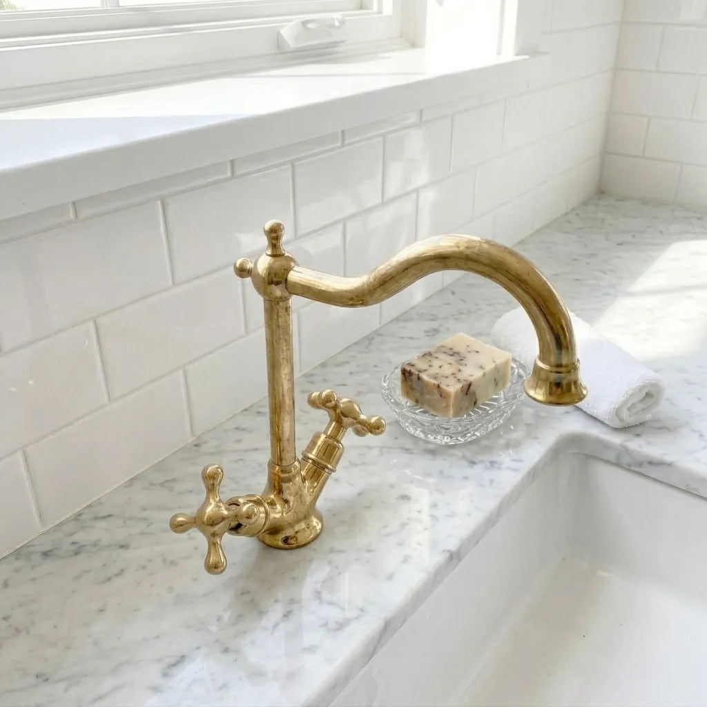 Solid brass deck mount sink faucet featuring a graceful curved spout and traditional dual handle design for timeless kitchen interiors