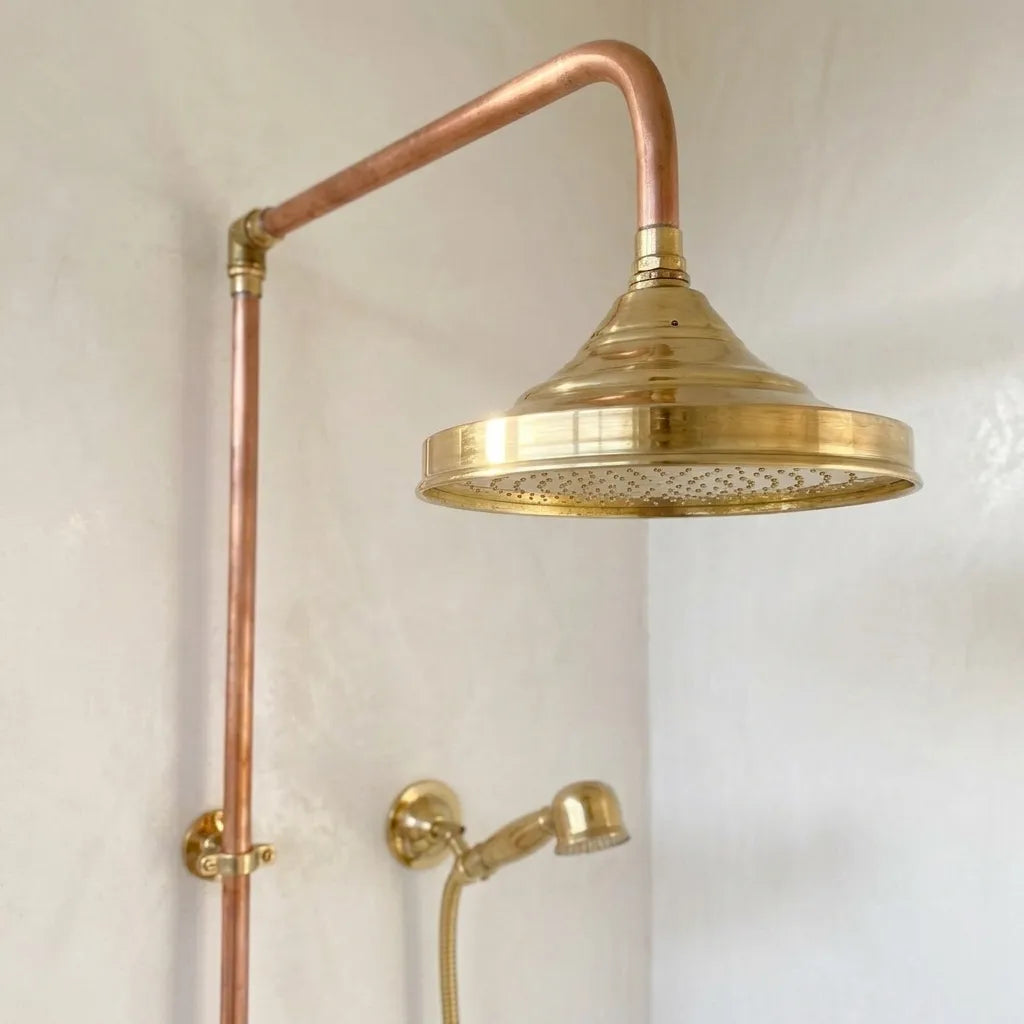 Luxury copper bathroom shower featuring brass rainfall head