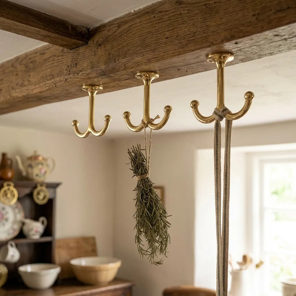 Luxury solid brass ceiling hook with two rounded arms for hanging pots, mugs, utensils, or decorative items.