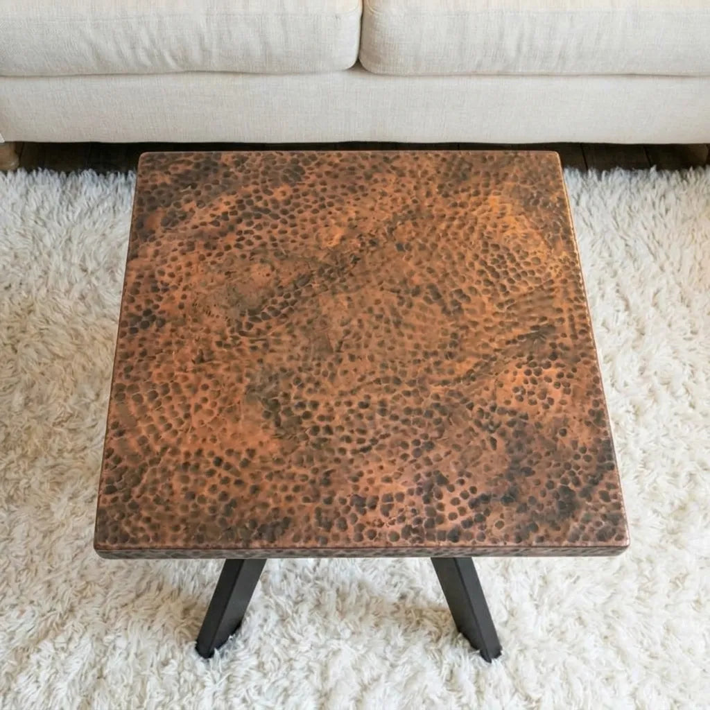 Square coffee table featuring a textured aged copper tabletop