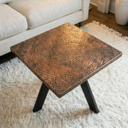 Hand-hammered aged copper coffee table with black steel base
