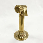 Unlacquered brass kitchen hand sprayer with trigger lever and deck-mounted holder