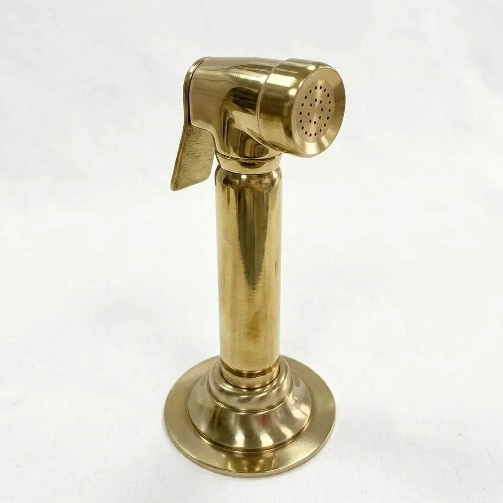 Unlacquered brass handheld rinse spray with polished cylindrical handle and spray nozzle