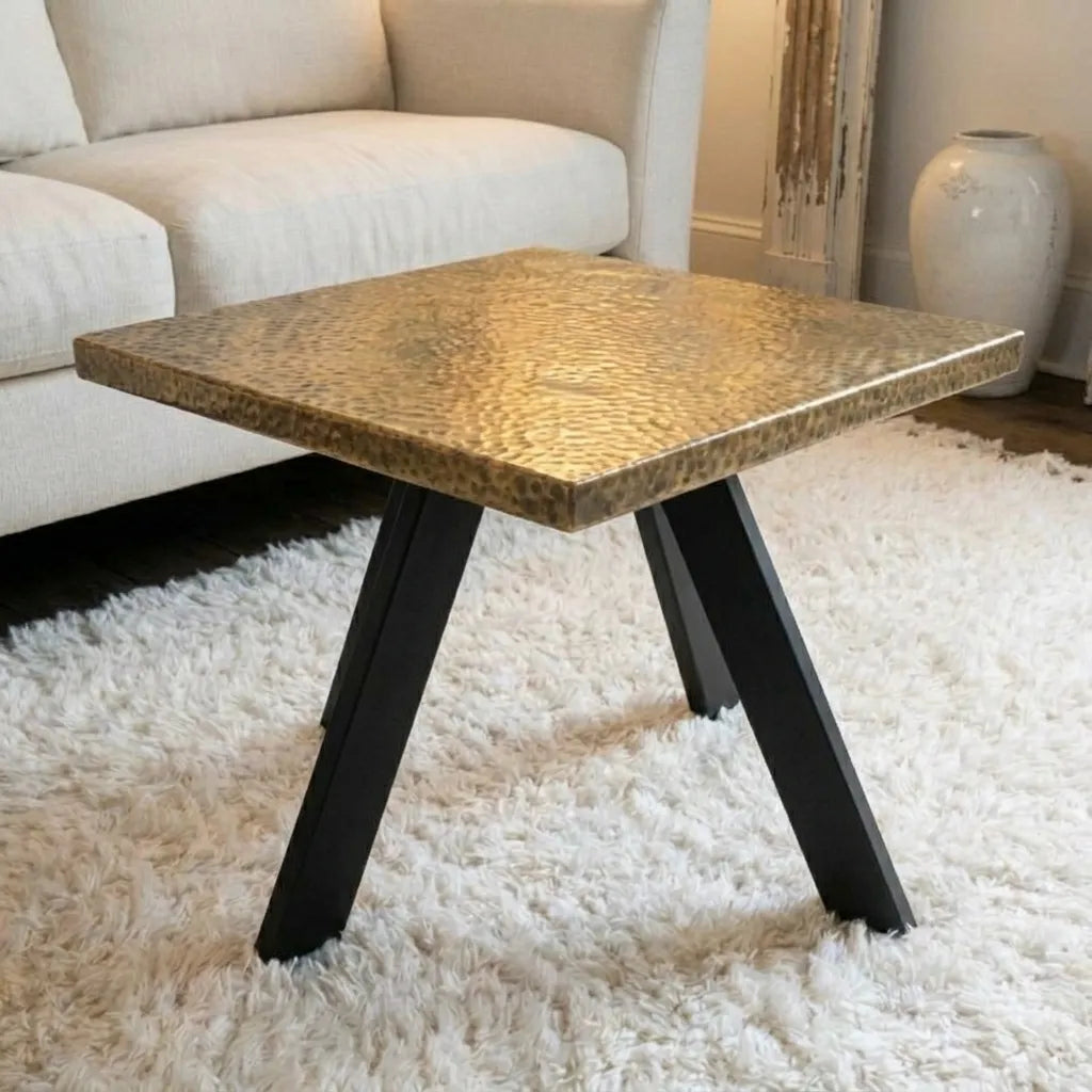 Handcrafted brass coffee table featuring uninterrupted hammered finish