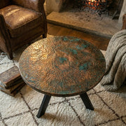 Verdigris Copper Coffee Table with Hammered Round Top and Rustic Fireplace Setting