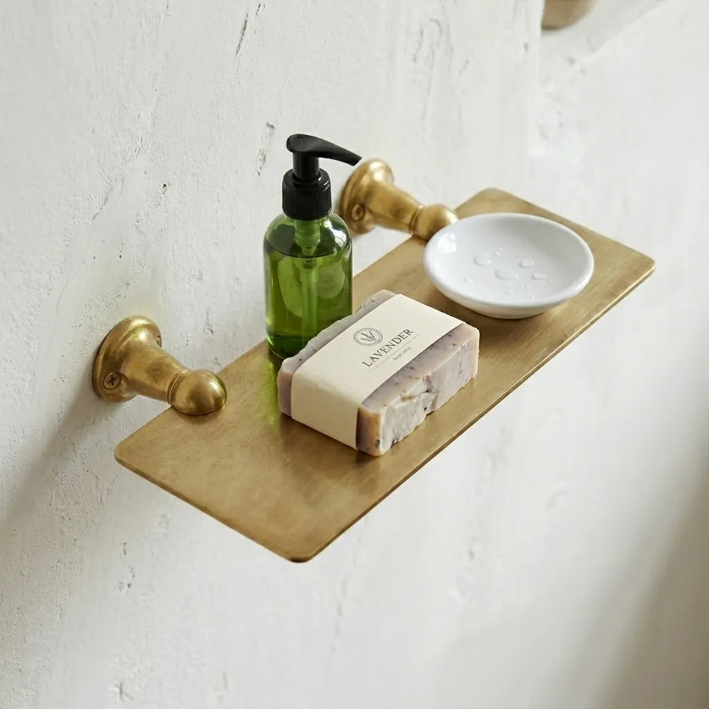 Luxury brass bathroom shelf offering compact storage for toiletries, skincare products, and everyday necessities