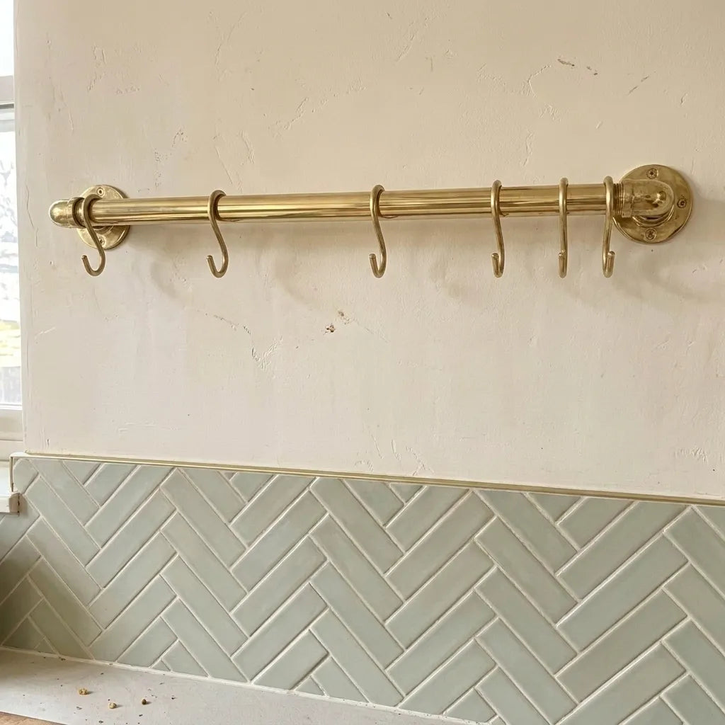 Handcrafted brass wall rail for cooking utensils and mugs