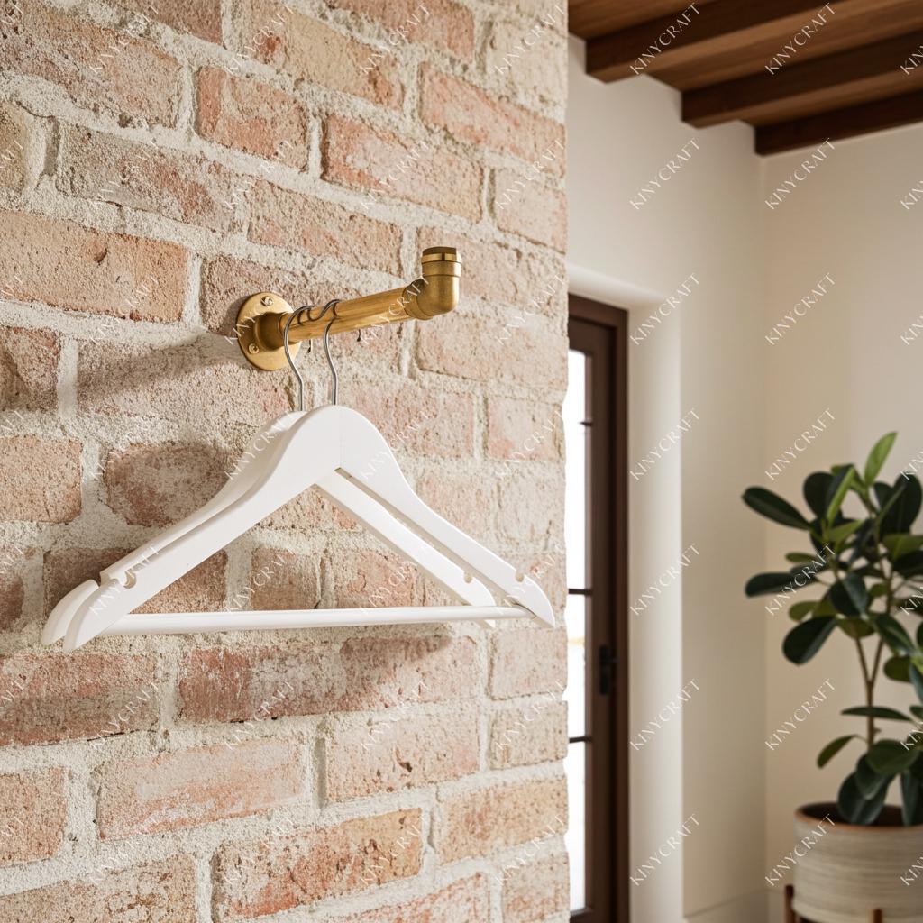 Handmade brass wall clothes rail with industrial pipe design