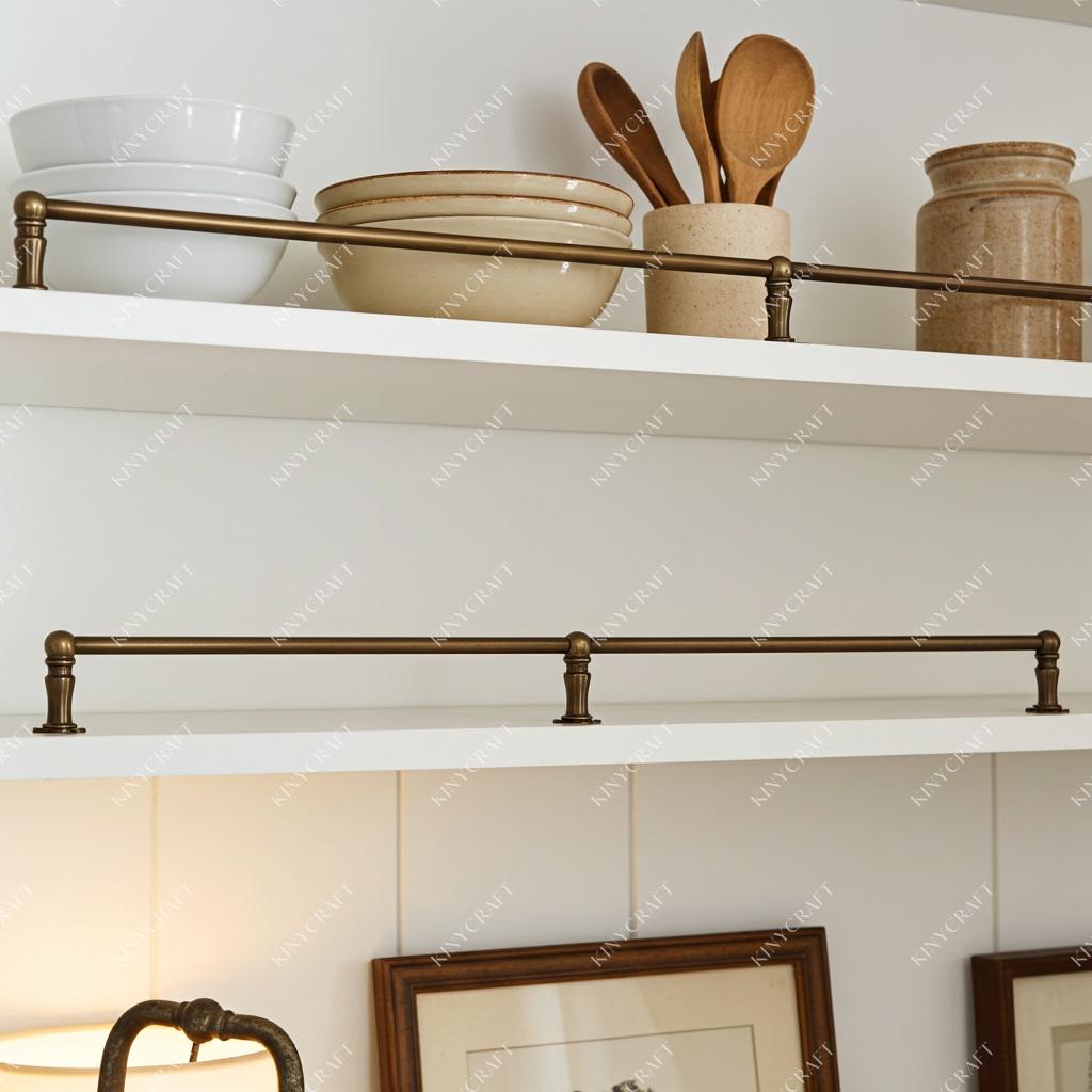 Wall mounted brass gallery rail with white shelf and ceramic kitchen containers.