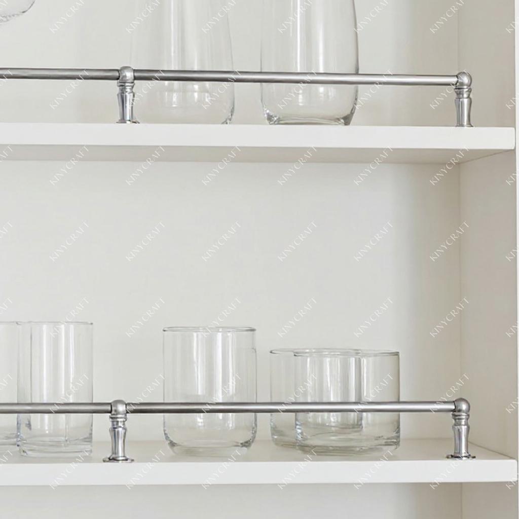 Chrome cabinet shelf rail installed on white open shelving with glassware storage.