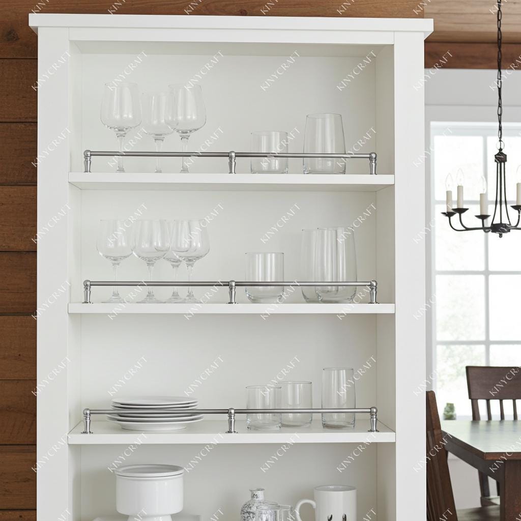Minimalist chrome cabinet rail system for kitchen organization and glassware display.