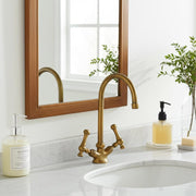 Unlacquered brass single hole bathroom faucet with cross handles
