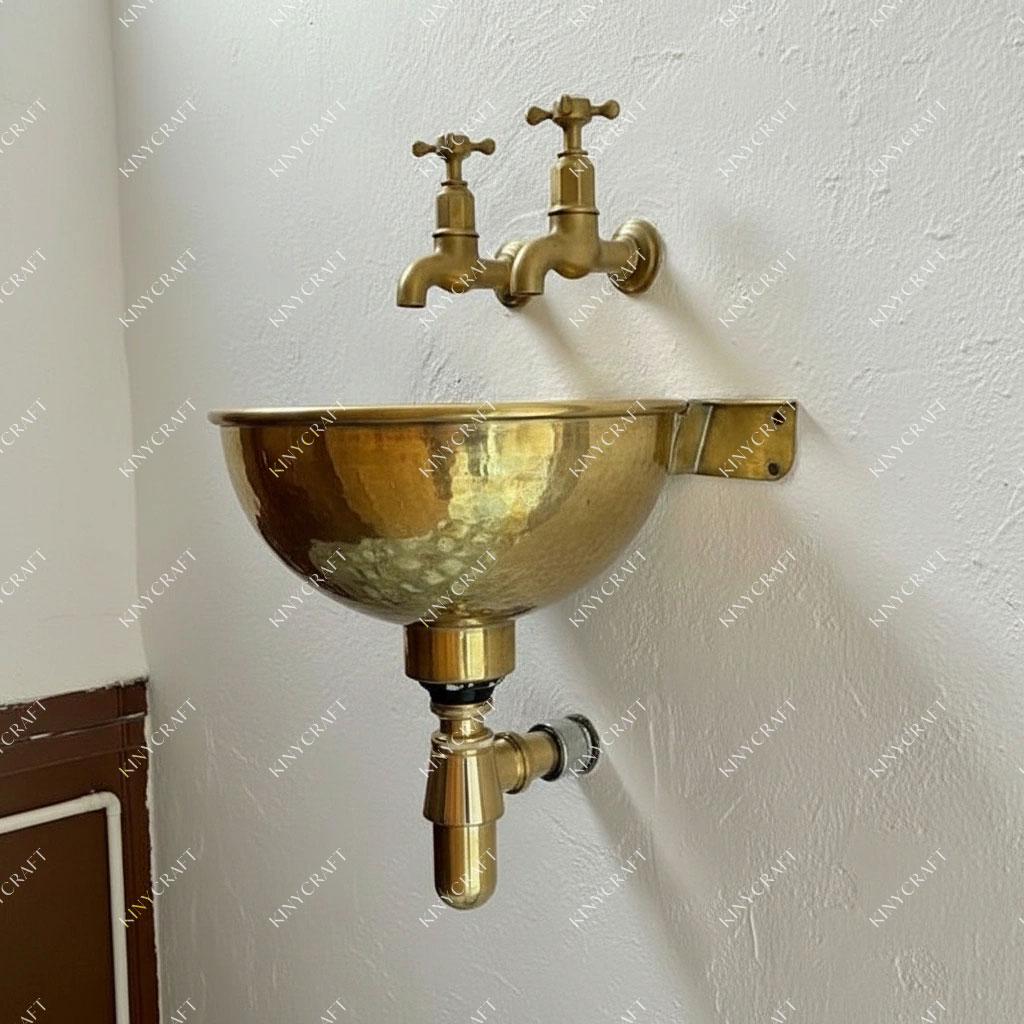 Solid brass wall-hung basin with hand-hammered texture and industrial-inspired bathroom design.