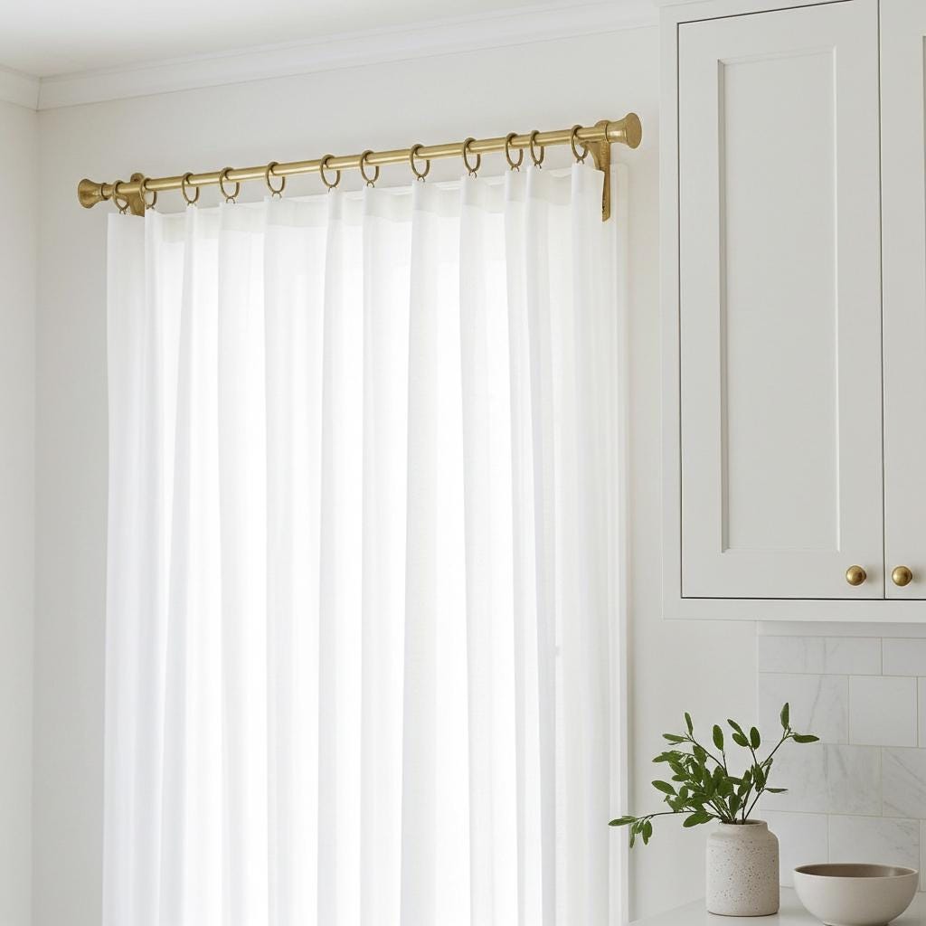Premium solid brass curtain rod with artisan hammered brackets, decorative finials, and smooth-glide curtain rings.