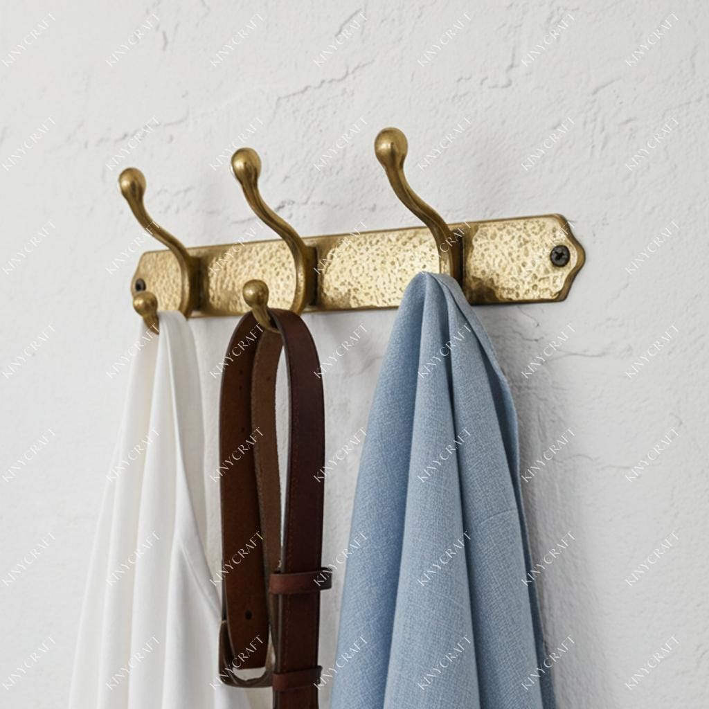 Handcrafted brass wall-mounted hook rack with hammered finish and six hanging points for home storage.