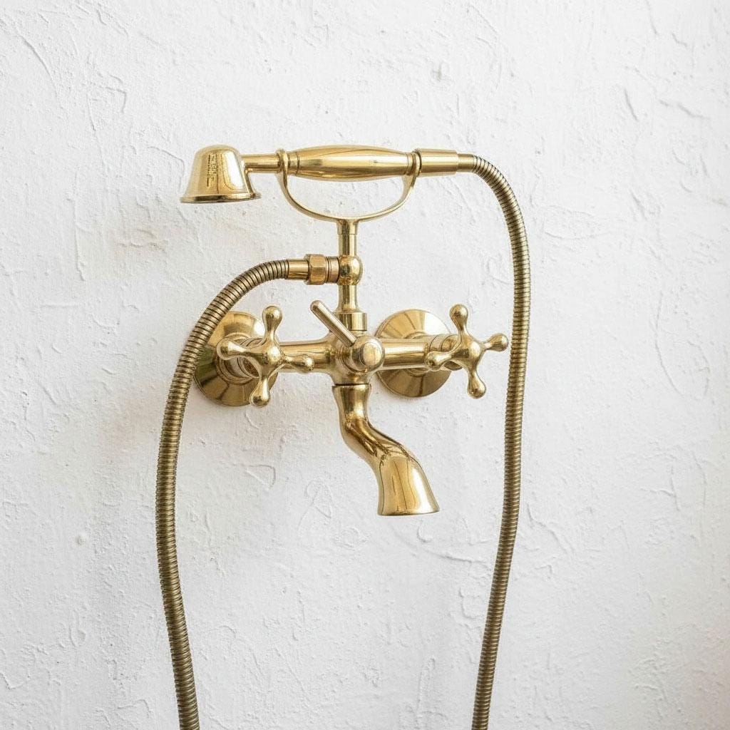 Unlacquered brass wall mount bathtub faucet with handheld shower