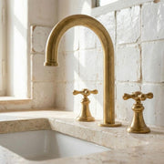 Unlacquered brass widespread bathroom faucet with high arc spout