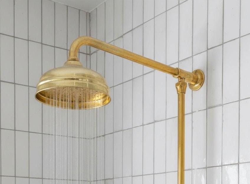 Vintage brass shower system with overhead rain shower, handheld spray, and cross handles