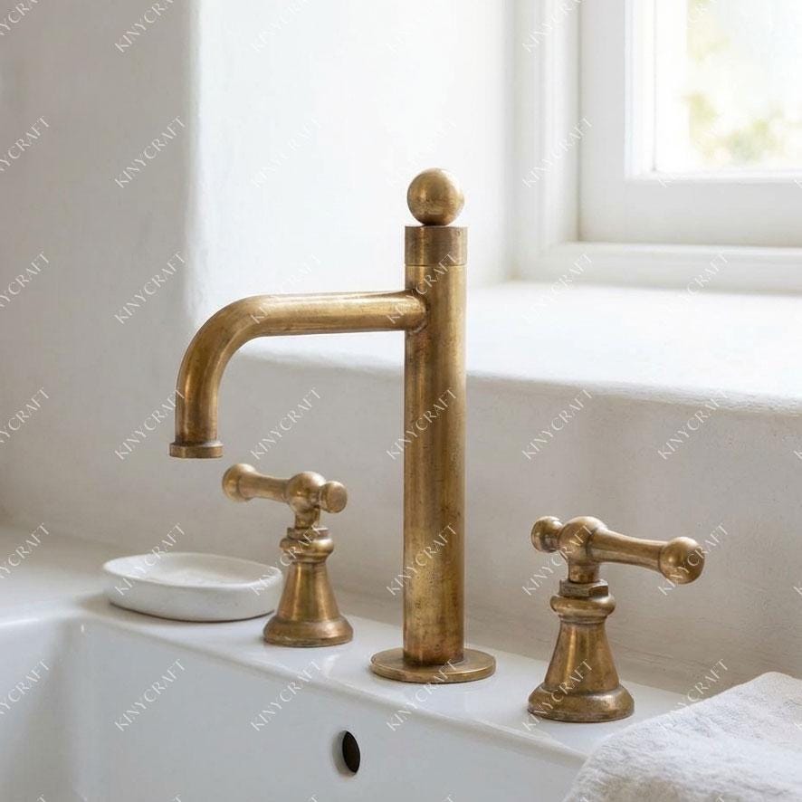 Luxury brass bathroom sink faucet featuring a timeless three-piece design.
