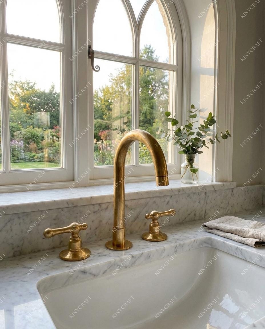 Luxury brass vanity faucet featuring high arc spout and dual lever controls in traditional bathroom.