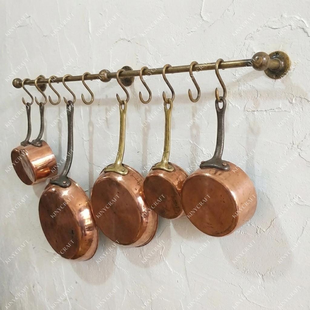 Vintage brass kitchen rail with hanging hooks for cookware and utensils