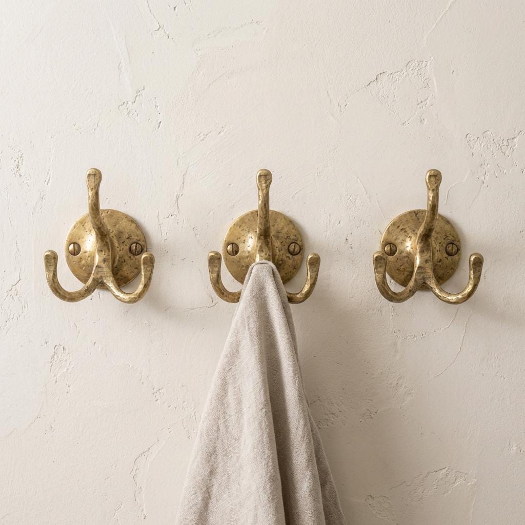 Solid brass wall mounted hook designed for hanging jackets, bags, hats, and accessories.